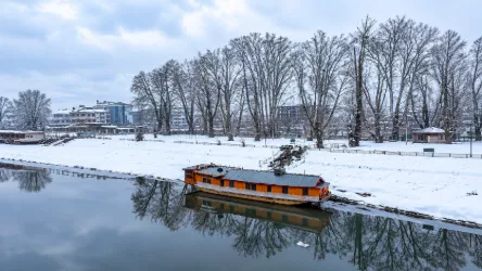 Traditional houseboat on a calm lake in Kashmir
