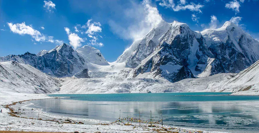 Gurudongmar Lake in Sikkim surrounded by snow-covered Himalayan mountains