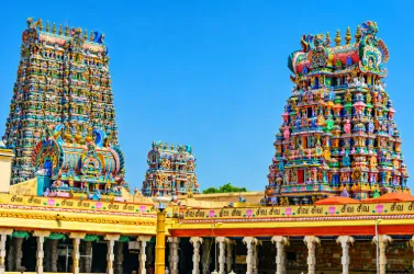 Colorful temple gopurams with intricate sculptures and traditional Dravidian architecture in Tamil Nadu